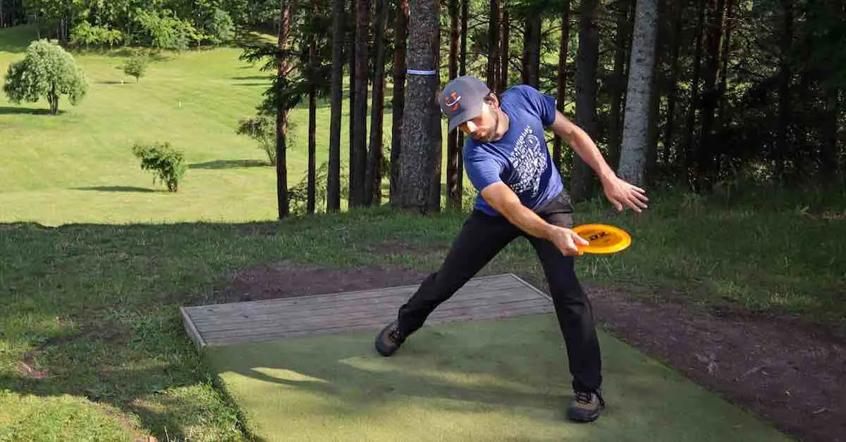 Disc golfer throwing on a beautiful course